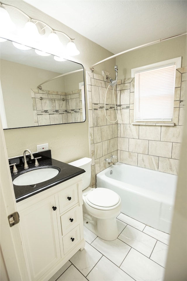 full bathroom featuring vanity, toilet, tile patterned floors, and tiled shower / bath