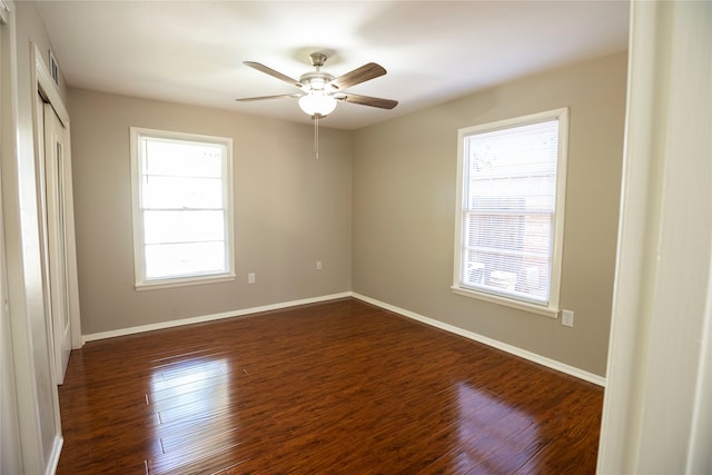 empty room featuring ceiling fan and dark hardwood / wood-style flooring