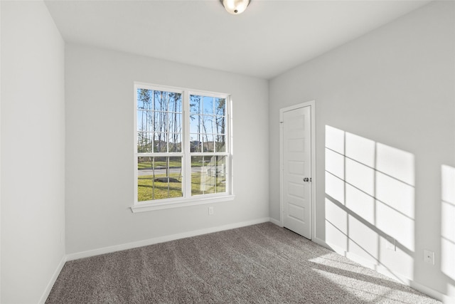 empty room with carpet flooring and baseboards