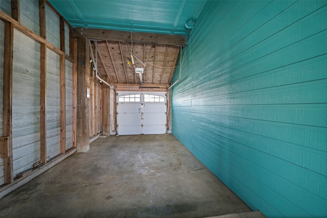 garage featuring wood walls