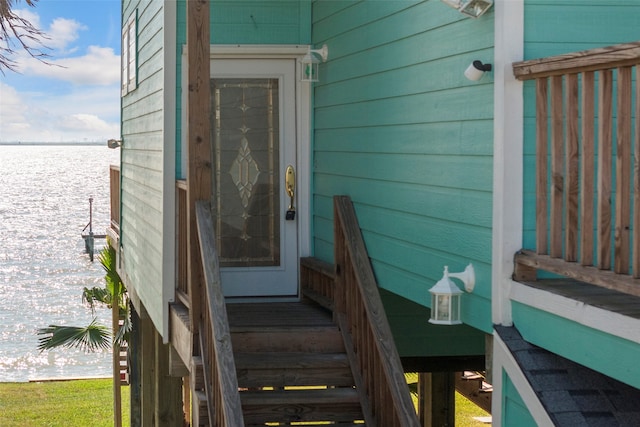 view of exterior entry with a water view