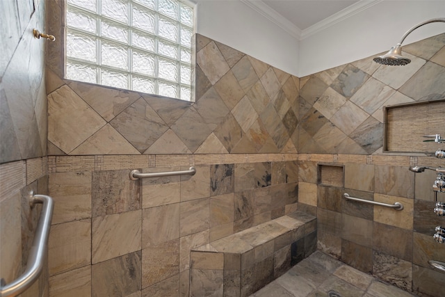 bathroom with ornamental molding and tiled shower