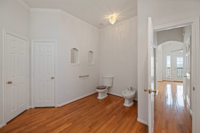 bathroom featuring ornamental molding, hardwood / wood-style flooring, a bidet, and ceiling fan