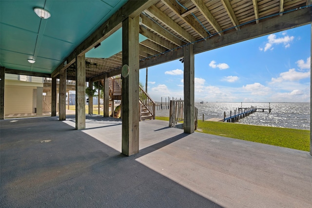 view of patio / terrace featuring a dock and a water view