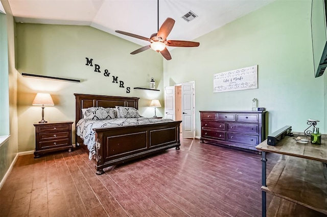 bedroom with dark hardwood / wood-style flooring, vaulted ceiling, and ceiling fan