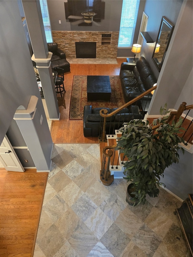 living room with a fireplace, hardwood / wood-style floors, and ceiling fan