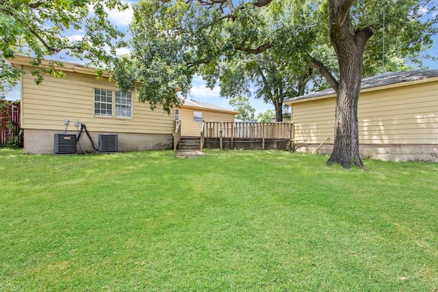 view of yard with a deck and central AC