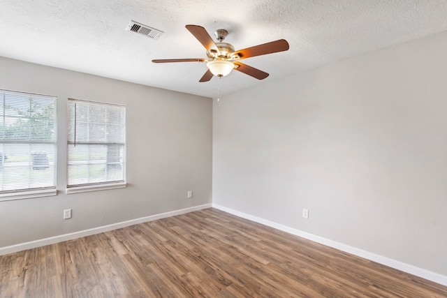 unfurnished room featuring a textured ceiling, hardwood / wood-style flooring, and ceiling fan