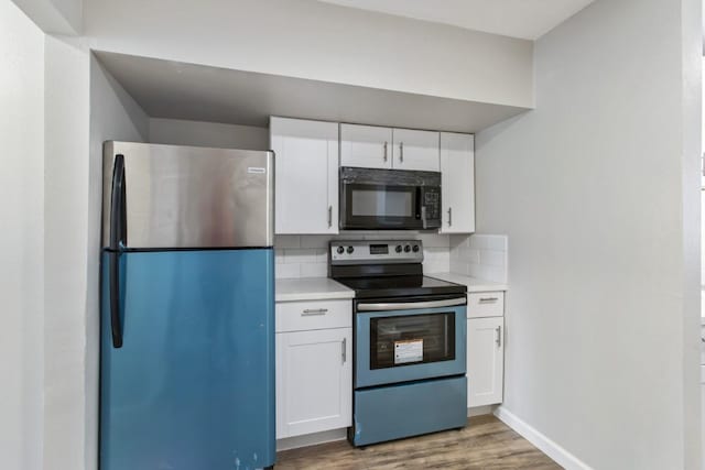 13210 Rockglen St, Houston, TX 77015 - kitchen with appliances with stainless steel finishes, wood finished floors, light countertops, and white cabinetry