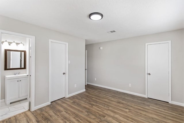 13210 Rockglen St, Houston, TX 77015 - unfurnished bedroom with wood finished floors and ensuite bathroom