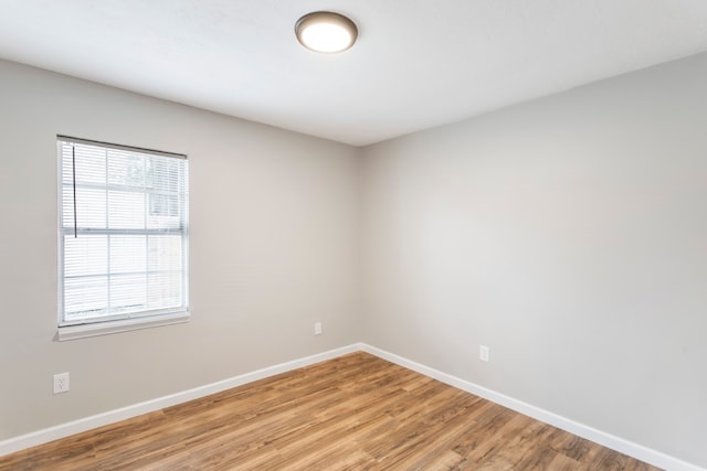 empty room with light hardwood / wood-style flooring