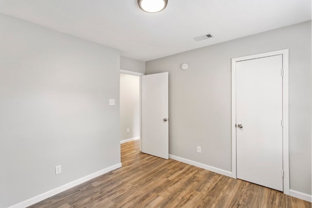 unfurnished bedroom featuring hardwood / wood-style floors