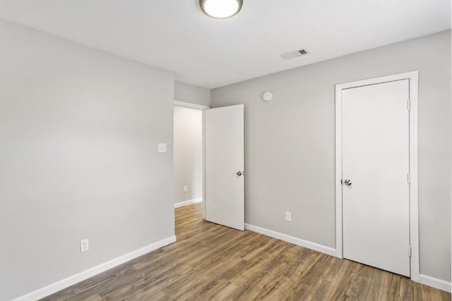 13210 Rockglen St, Houston, TX 77015 - unfurnished bedroom with wood finished floors and baseboards