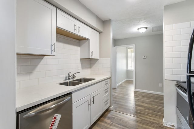 13210 Rockglen St, Houston, TX 77015 - kitchen with stainless steel appliances, tasteful backsplash, light countertops, white cabinetry, and dark wood finished floors