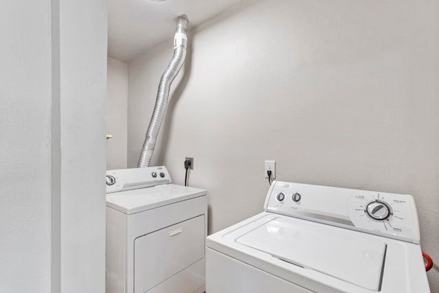 clothes washing area featuring washing machine and clothes dryer