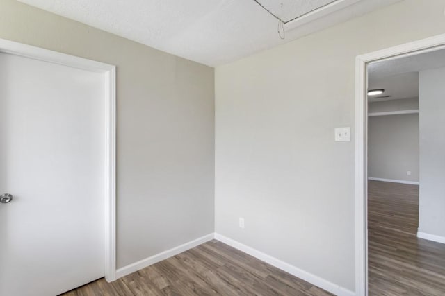 13210 Rockglen St, Houston, TX 77015 - unfurnished bedroom with wood finished floors and attic access