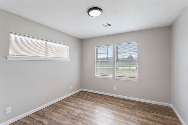 unfurnished room featuring dark wood-type flooring