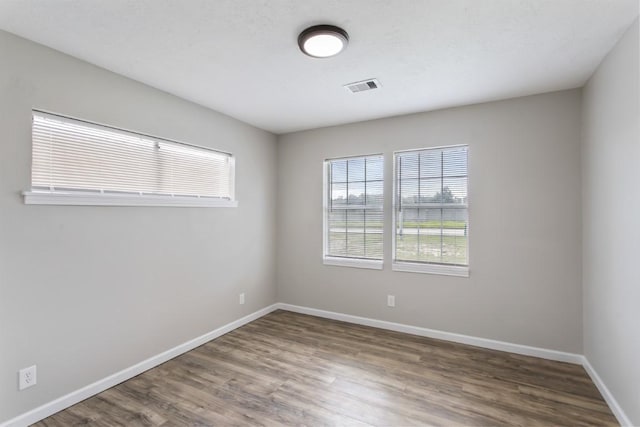 13210 Rockglen St, Houston, TX 77015 - empty room featuring healthy amount of natural light and wood finished floors