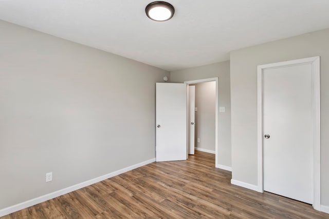 unfurnished bedroom featuring dark wood-type flooring