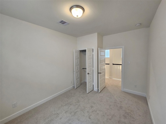 unfurnished bedroom featuring light colored carpet