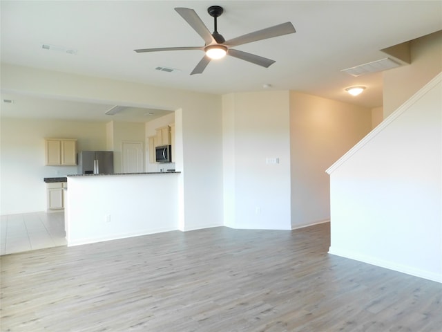 unfurnished living room with light hardwood / wood-style floors and ceiling fan