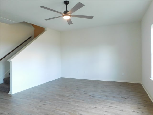 empty room featuring ceiling fan and light hardwood / wood-style flooring