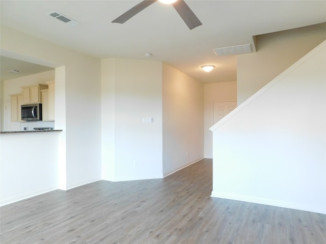 empty room featuring light hardwood / wood-style floors and ceiling fan