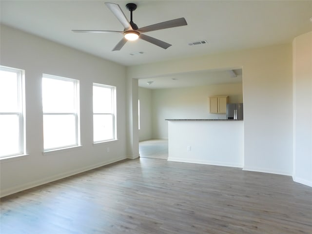 unfurnished living room featuring light hardwood / wood-style floors and ceiling fan