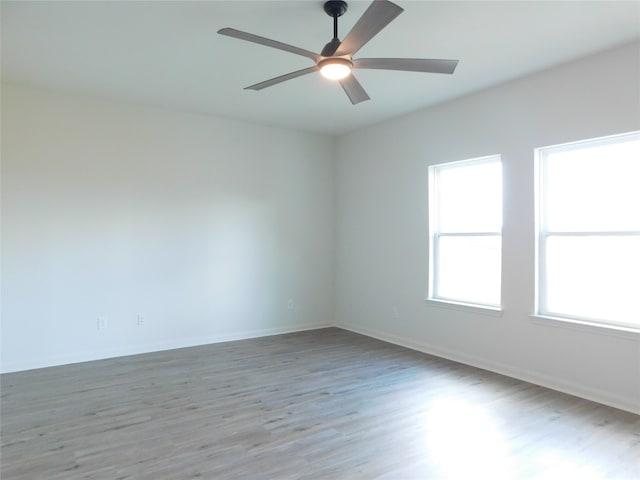 spare room with light hardwood / wood-style flooring and ceiling fan