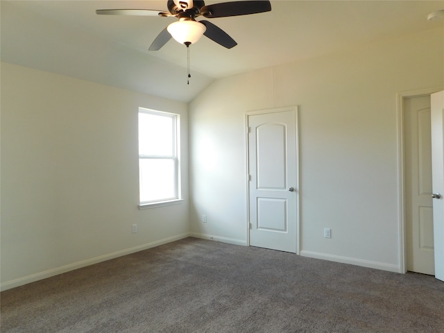 carpeted empty room with ceiling fan and lofted ceiling