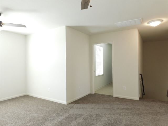 spare room with light carpet and ceiling fan