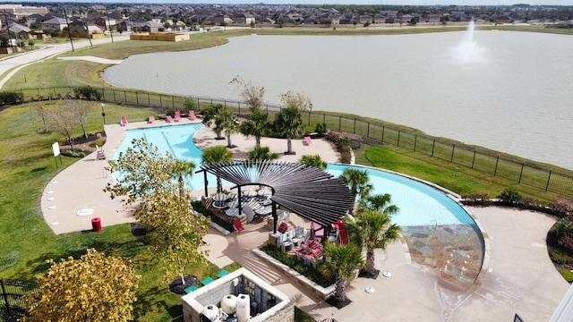 view of pool with a water view, a patio, and a yard