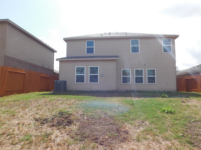 rear view of house featuring a yard and cooling unit