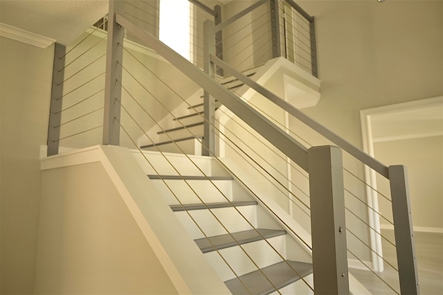 stairway featuring crown molding