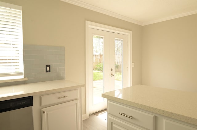 doorway featuring crown molding, a healthy amount of sunlight, and french doors