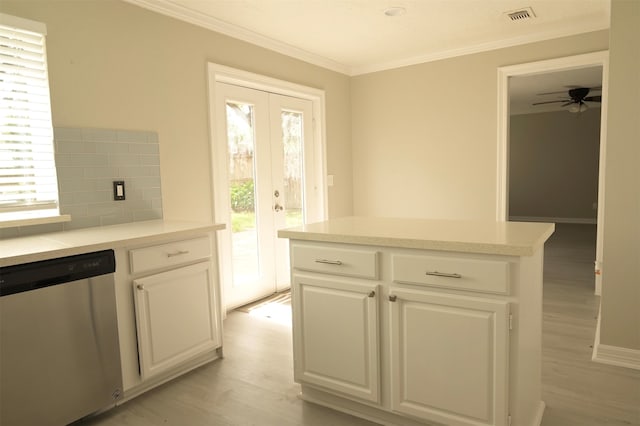 kitchen with dishwasher, white cabinets, decorative backsplash, and light hardwood / wood-style floors