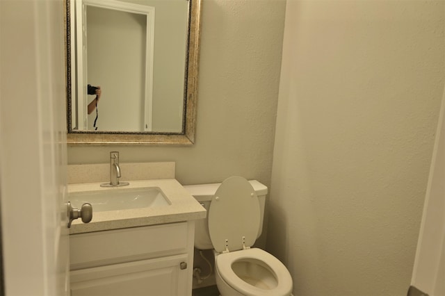 bathroom with toilet and vanity