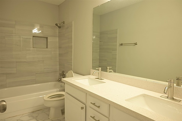 full bathroom with vanity, tiled shower / bath combo, and toilet