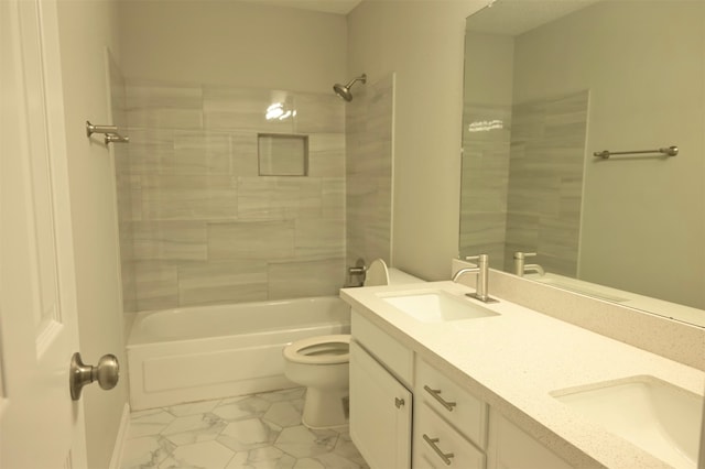 full bathroom featuring vanity, toilet, and tiled shower / bath