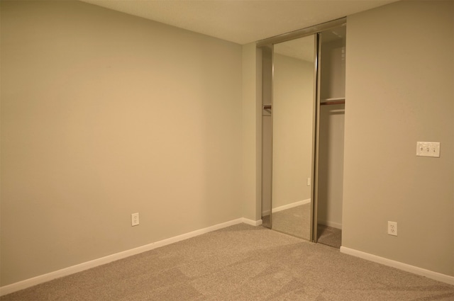 unfurnished bedroom with carpet and a closet