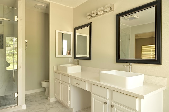 bathroom with a shower with door, vanity, and toilet