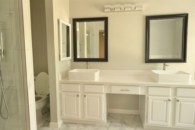 bathroom featuring vanity, toilet, and an enclosed shower