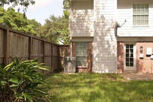 exterior space with a yard and central AC unit