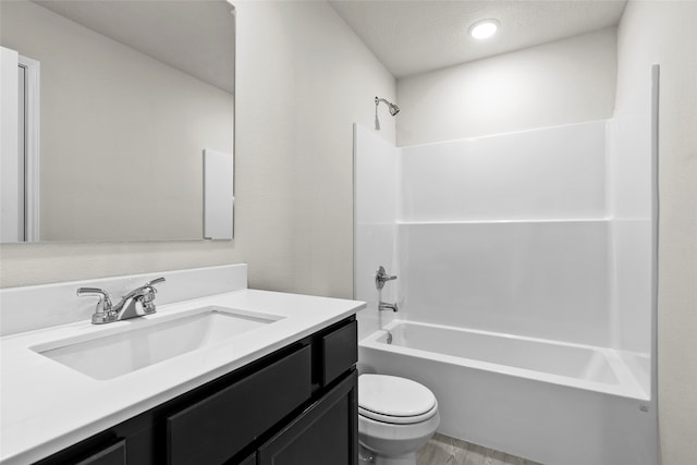 full bathroom with  shower combination, hardwood / wood-style flooring, vanity, and toilet