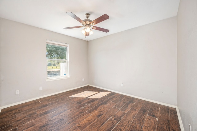 empty room with ceiling fan and dark hardwood / wood-style flooring