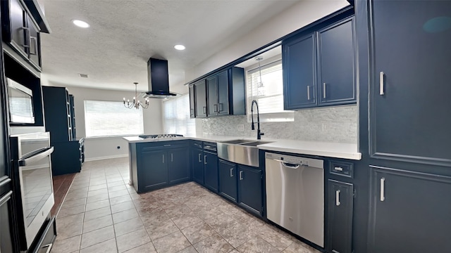 kitchen with kitchen peninsula, extractor fan, sink, pendant lighting, and stainless steel appliances