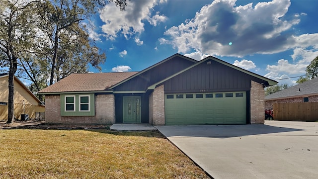 ranch-style home featuring a front yard and a garage