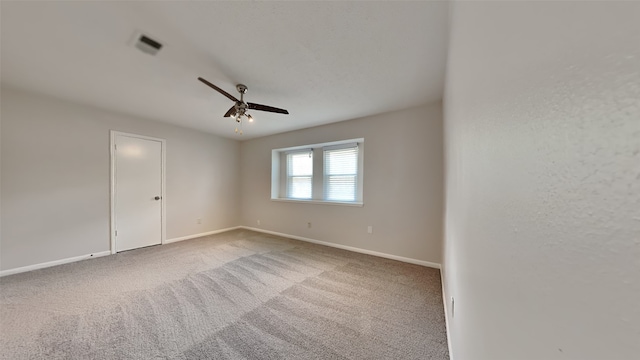 empty room with ceiling fan and carpet flooring