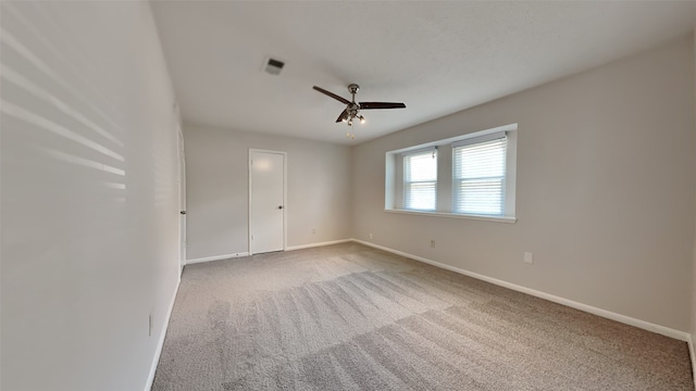 carpeted empty room featuring ceiling fan