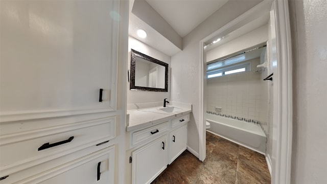 full bathroom with toilet, tiled shower / bath combo, and vanity